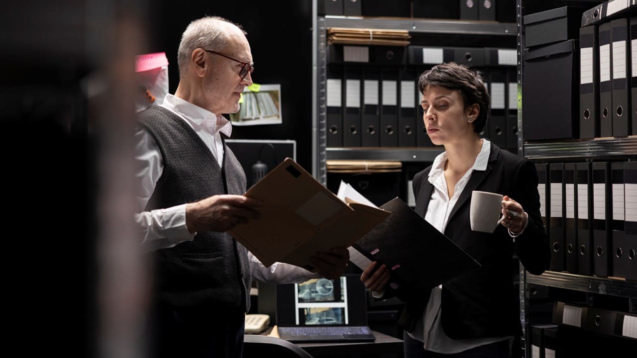 Two professionals reviewing a physical document